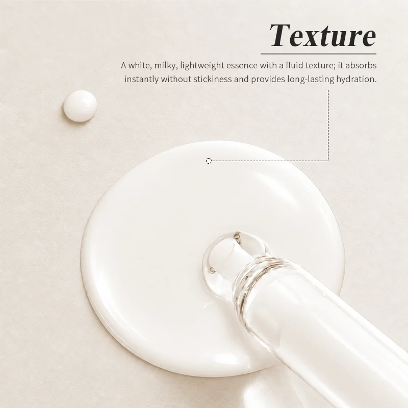 A creamy, white milky essence with a lightweight texture shown with a dropper placed in a small pool of the product.